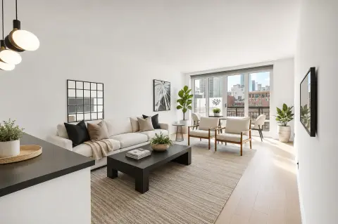 Open-plan living room with beige sofa, black coffee table, wooden chairs, large windows overlooking city skyline, and pendant lighting.